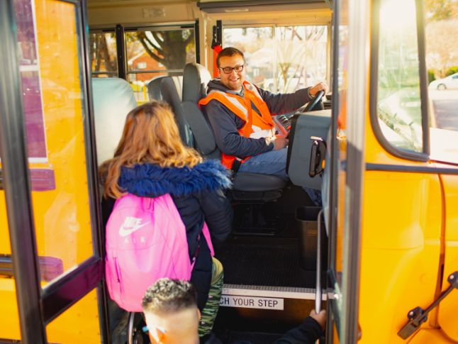  Photo of student boarding school bus